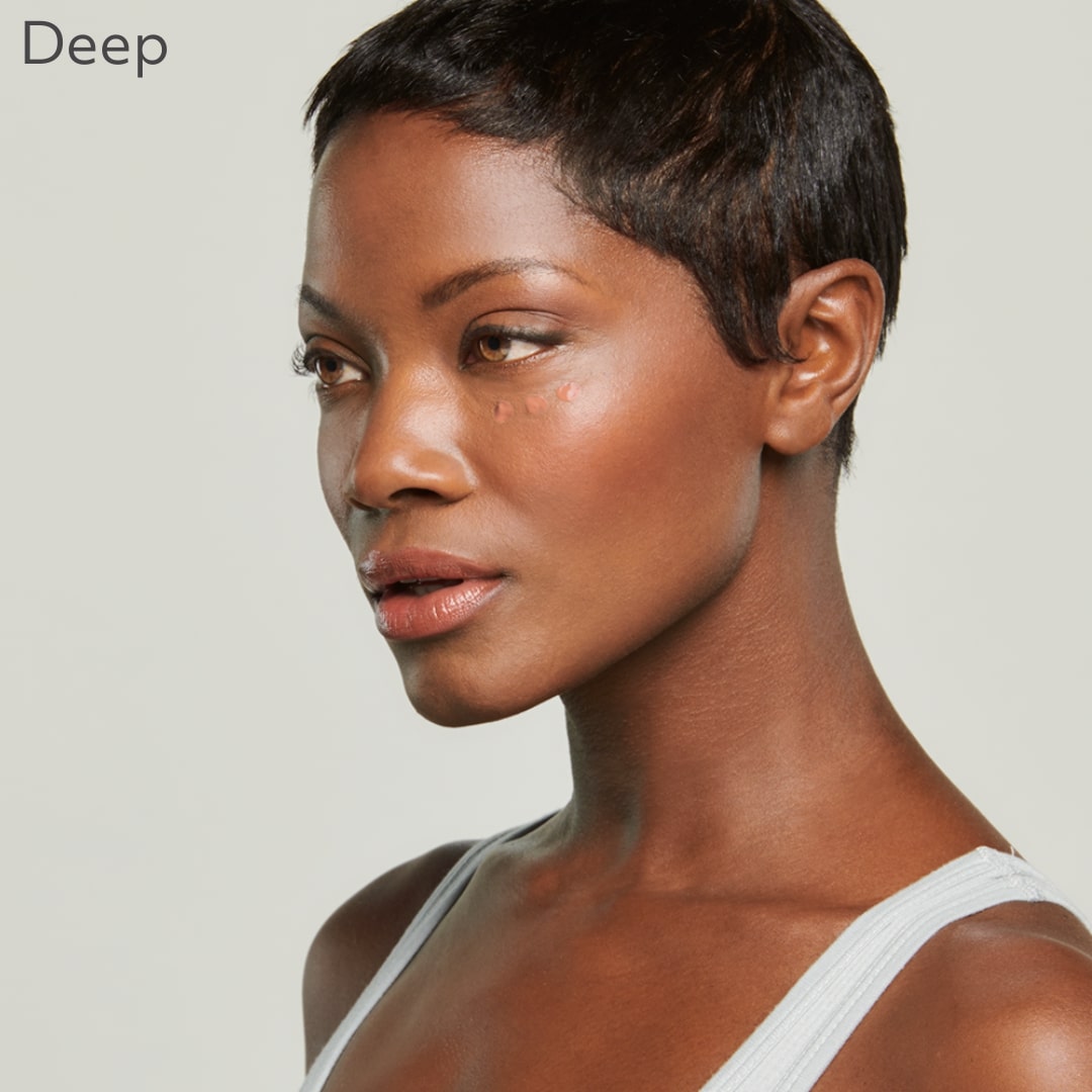 Woman displaying Total Eye® 3-IN-1 Renewal Therapy in deep shade