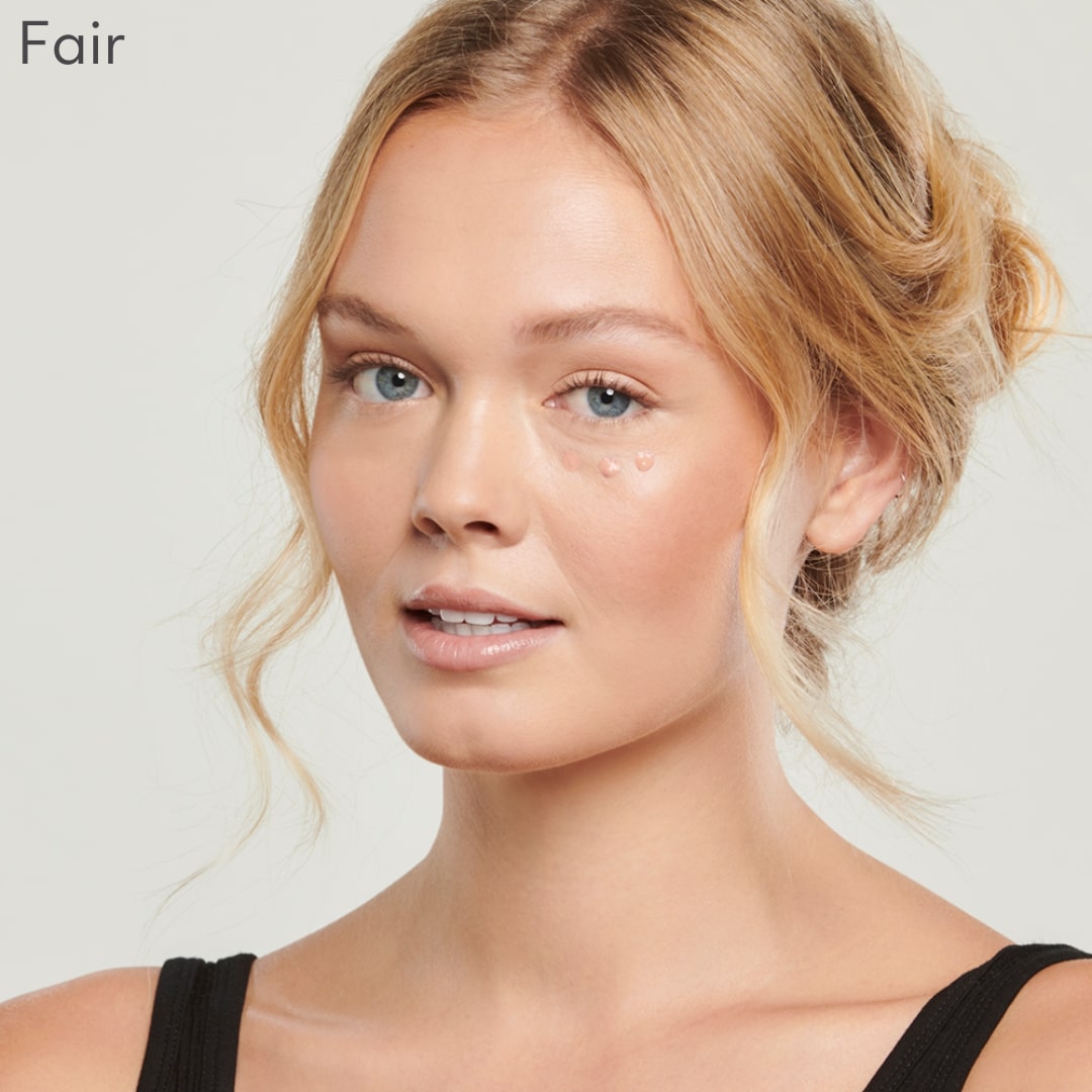Woman displaying Total Eye® 3-IN-1 Renewal Therapy in fair shade