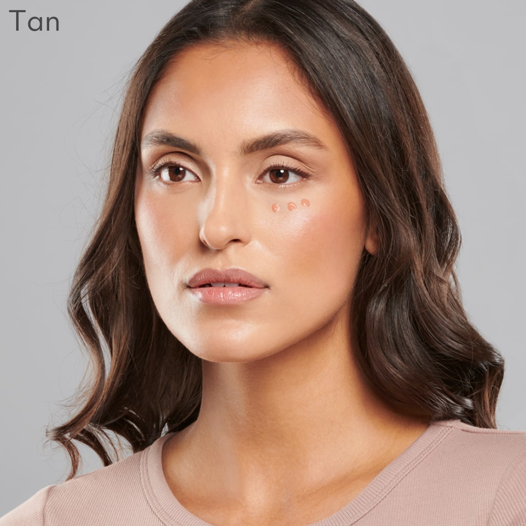 Woman displaying Total Eye® 3-IN-1 Renewal Therapy in tan shade