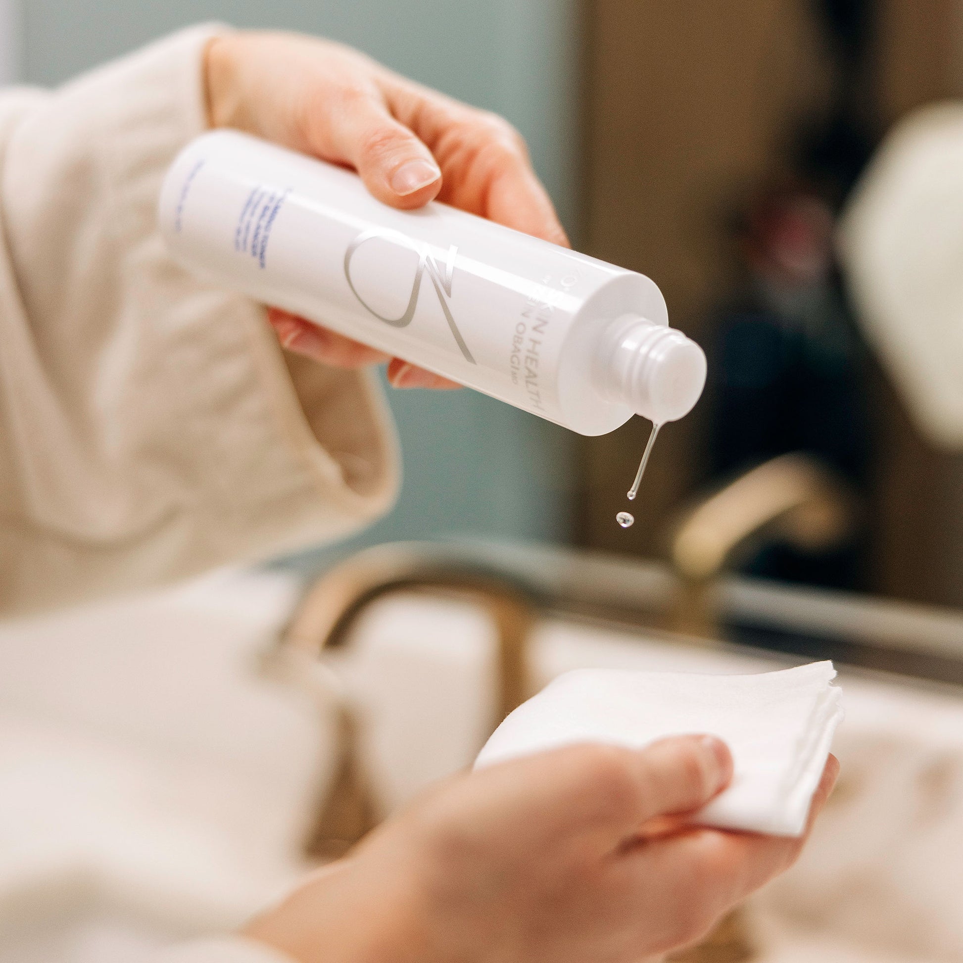 A woman using the ZO Calming Toner Balancer as a part of her morning skincare routine