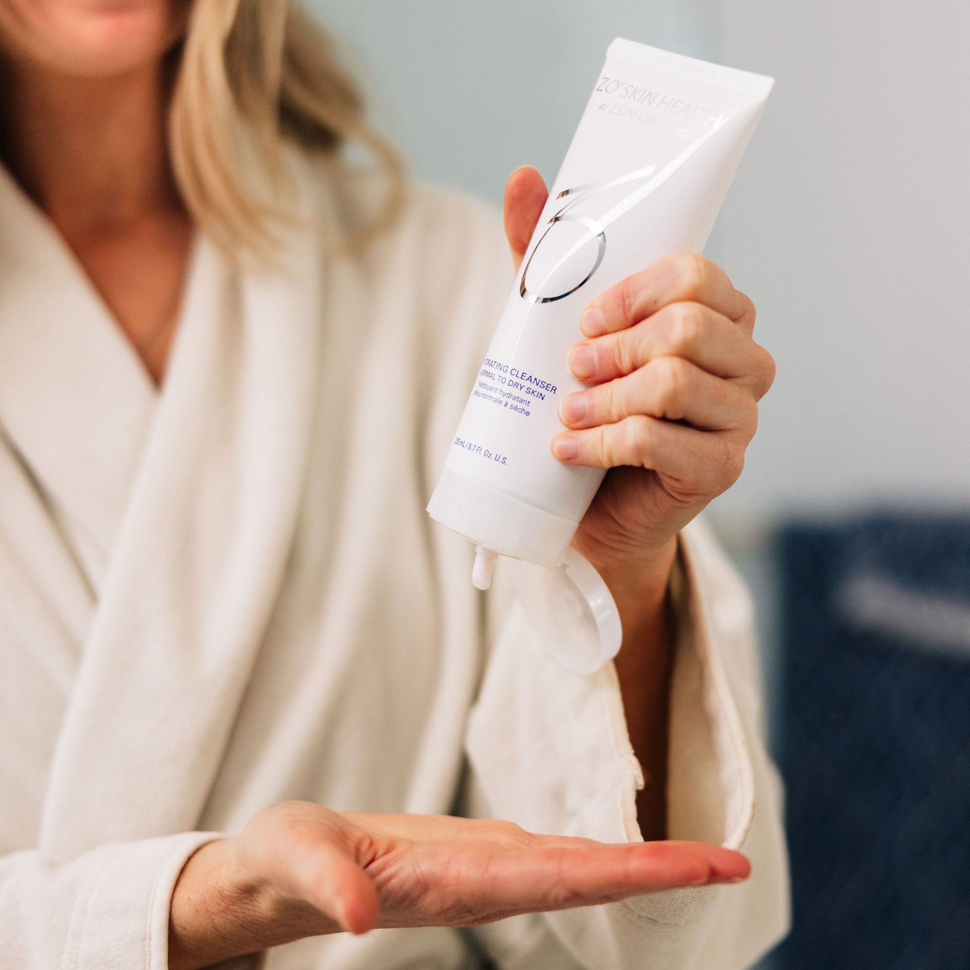 A woman using ZO Skin Health Gentle Cleanser during her skincare routine