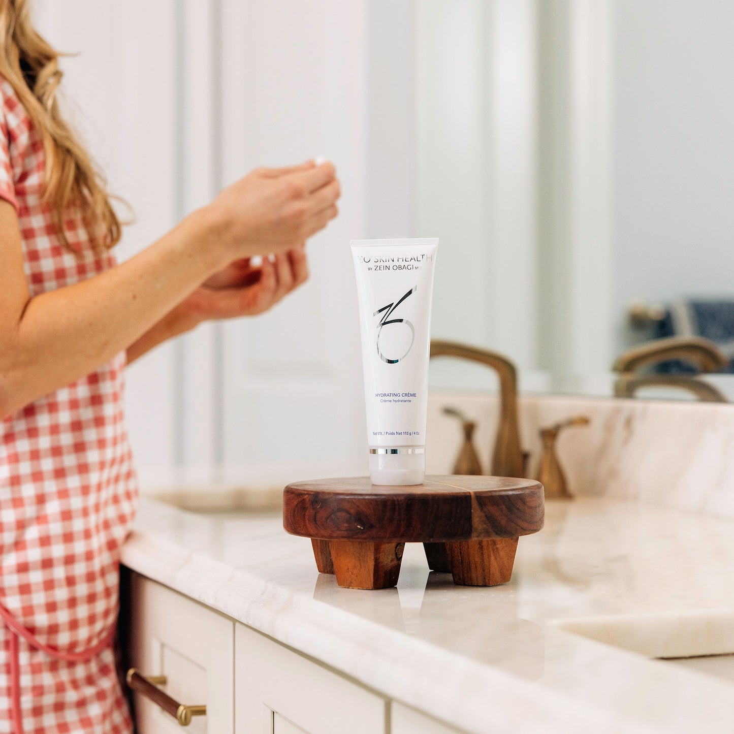 A woman using ZO Skin Health Hydrating Creme during her skincare routine