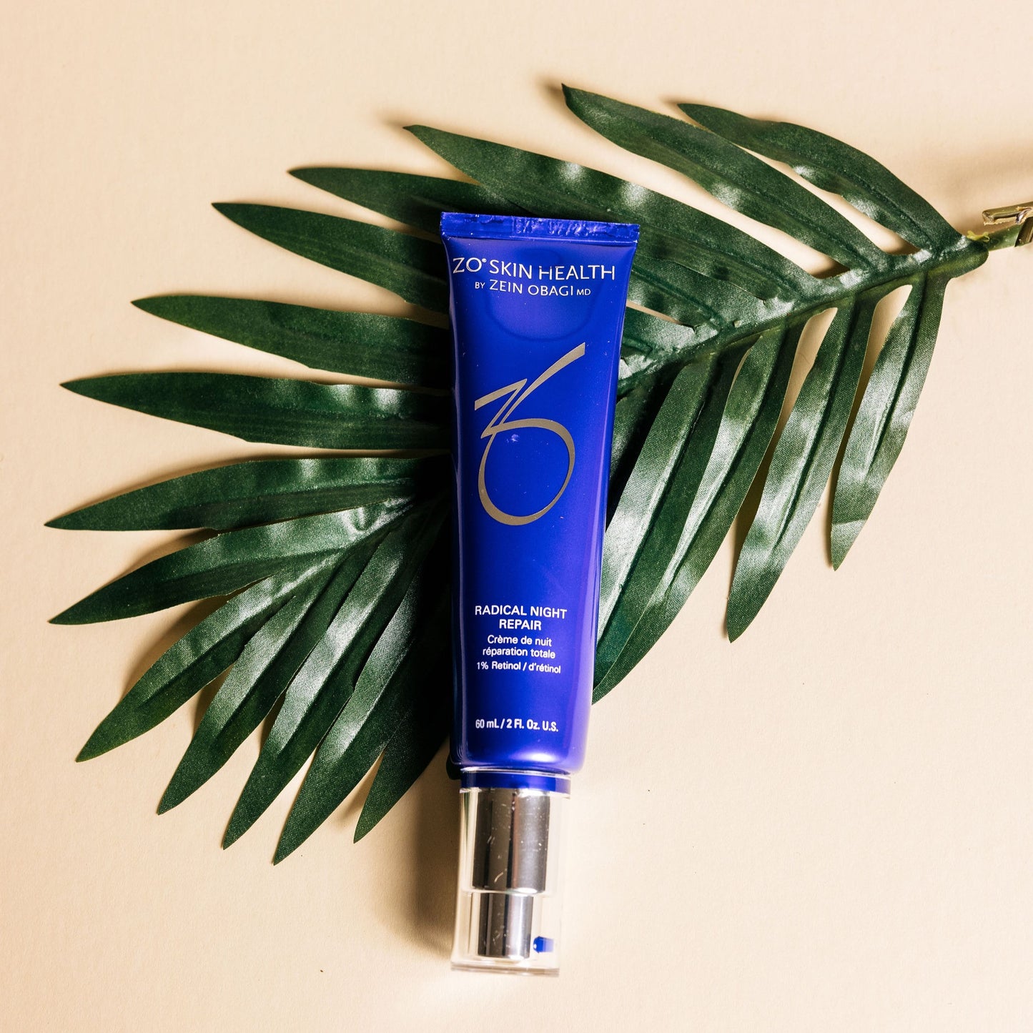 Radical Night Repair from ZO Skin Health on a palm leaf background