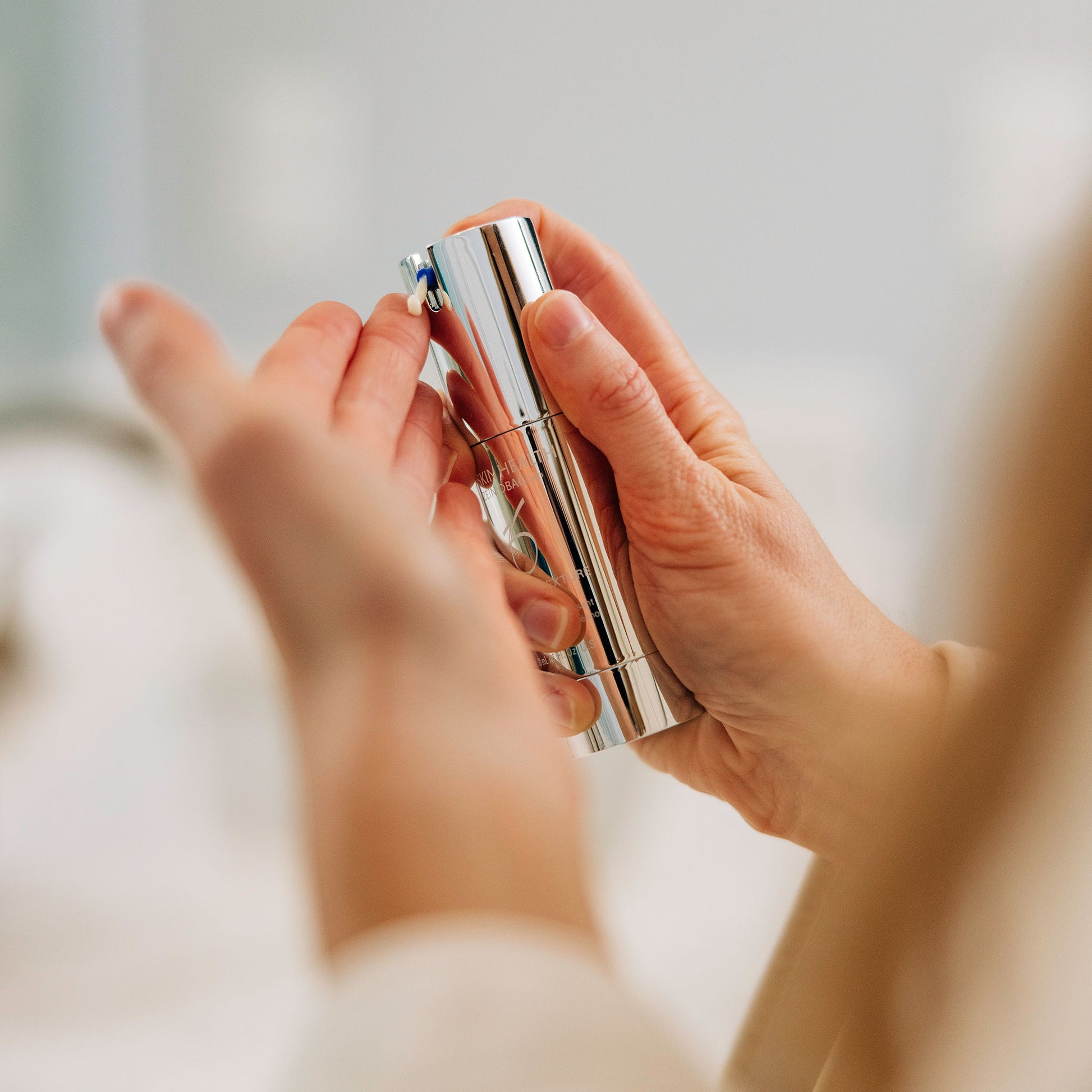 A woman dispensing the Wrinkle + Texture Repair in Travel Size on her finger