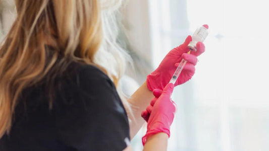 Photo of a woman putting tox into a syringe for a tox treatment