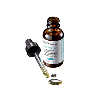 Open bottle of SkinCeuticals Phloretin CF with drop applicator dispensing serum 