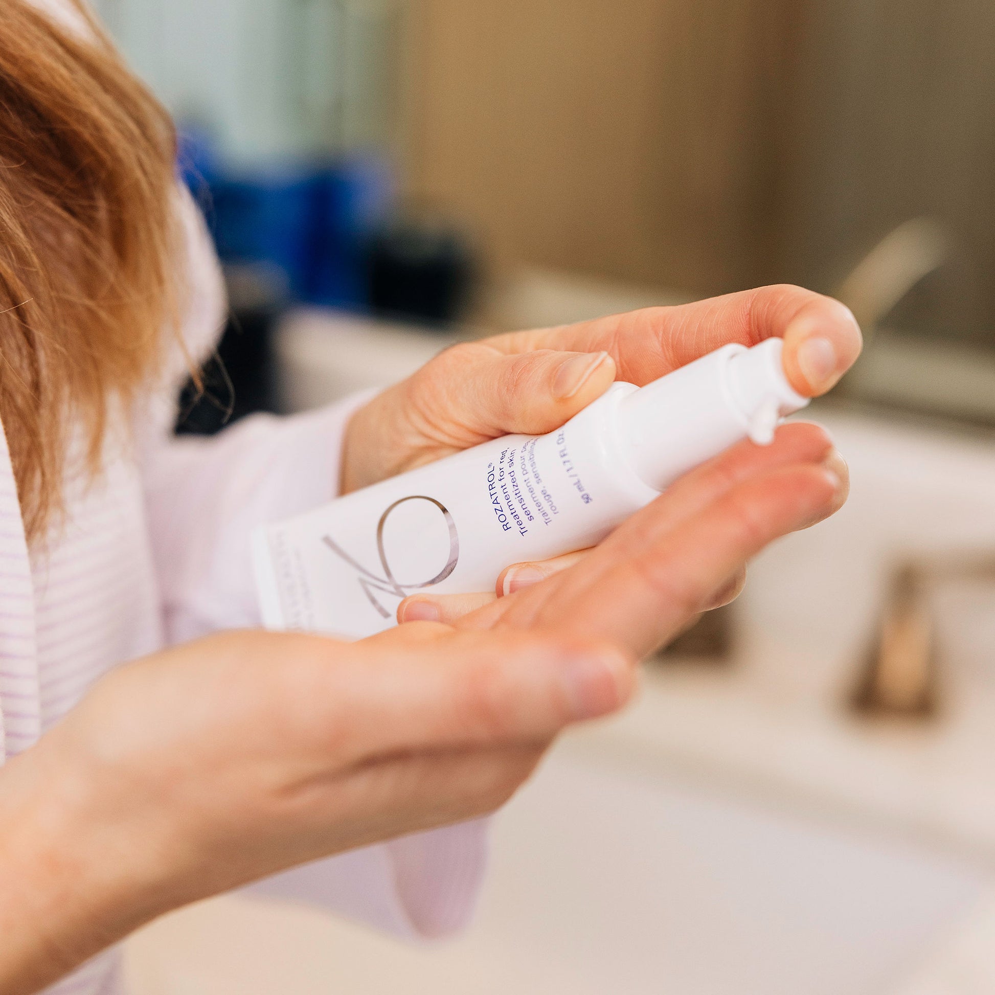 A woman using the ZO Skin Health Rozatrol as a part of her morning skincare routine